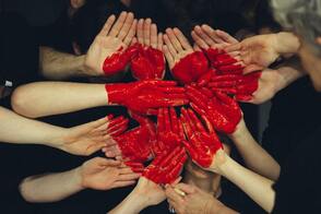 group of hands with painted heart